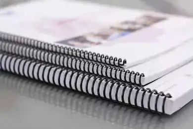 coil bound project manual on table